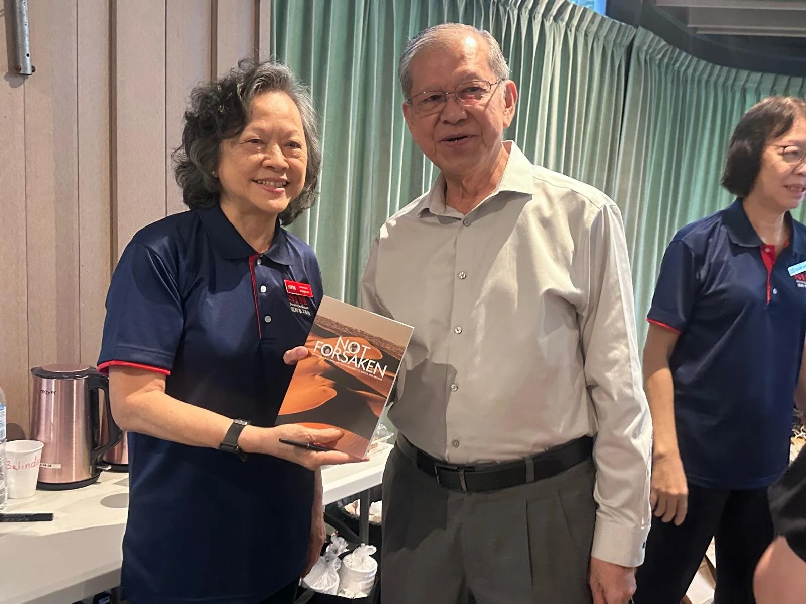 Belinda presented Dr Ng's book to Rev David Wong